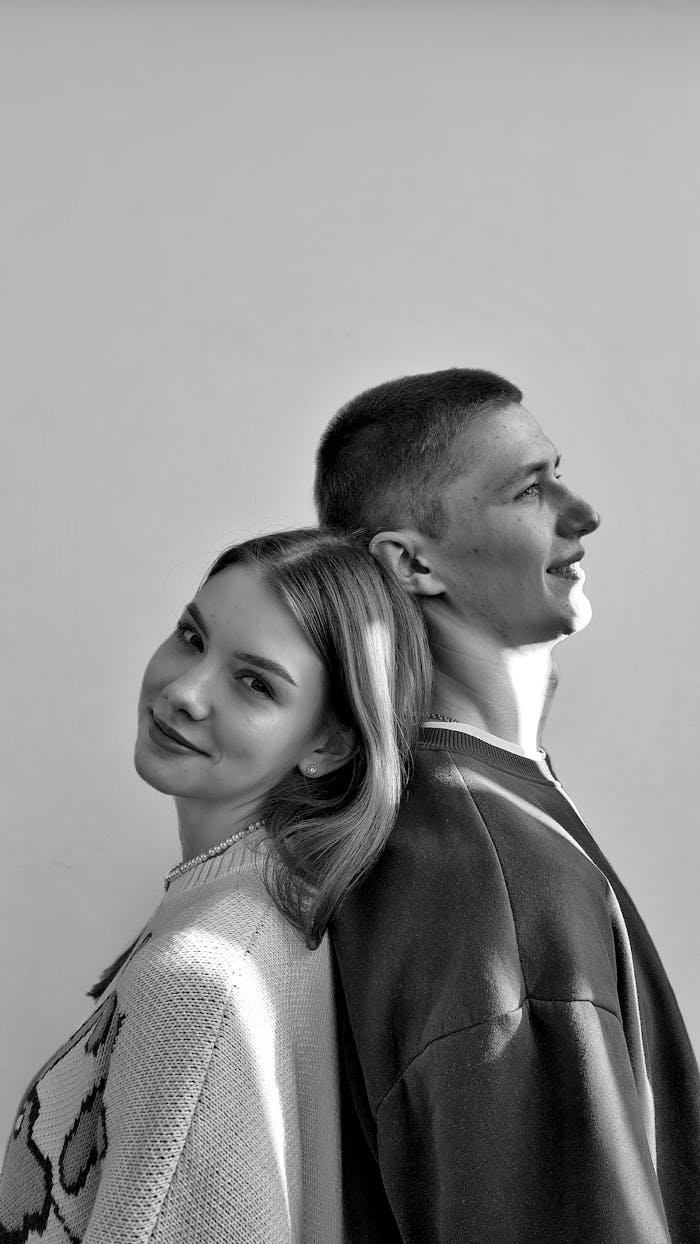 Elegant black and white portrait capturing a young couple in a moment of affection and togetherness.