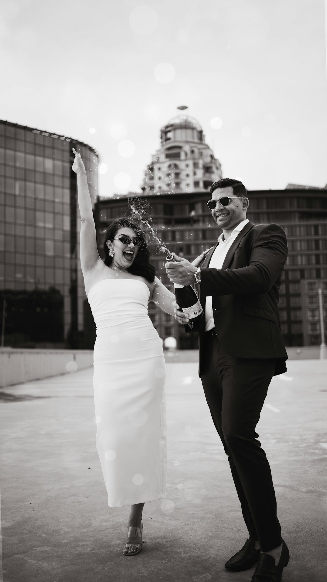 Save the date wedding invitation photoshoot of the bride and groom popping champagne :)